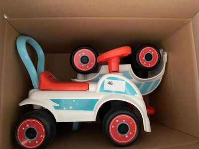 a toy car in a cardboard box with wheels on it