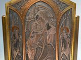 an image of a metal plaque with a picture of a man holding a child