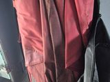 a black bag and a red bag sitting on a chair