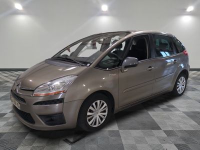 the small car is parked on the checkered floor in the garage