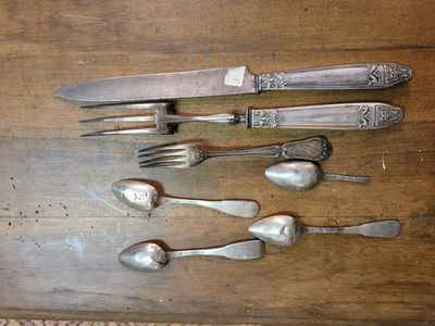 a wooden table with silverware and spoons on it