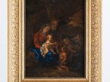 une image représentant un tableau posé sur un chevalet, sur lequel figure une femme tenant un enfant dans ses bras