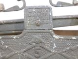 a close up of a metal bench with a sign on it