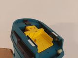 a person holding a blue and yellow object in their hand