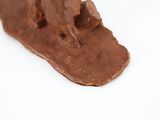 brown dog figurine on a white surface with a white background