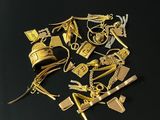 a pile of gold jewelry on a black surface
