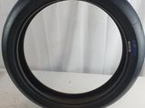 someone is holding a tire that has been placed on a table