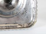 a close up of a metal object on a white surface