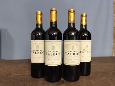 three bottles of red wine sit on a table in front of a blue wall