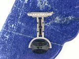 a picture of a diamond and black onyx watch on a blue marble slab