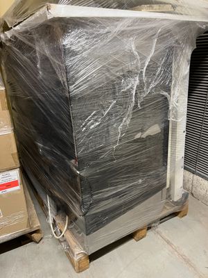 a large television sitting on top of a pallet in a warehouse