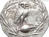 an image of a silver coin with an owl on top of it