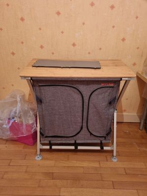 a laptop sitting on a folding chair in a room