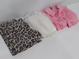a pile of clothes on a white surface next to a mirror