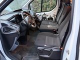 a white van with the door open and the driver ' s seat down