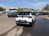 a white car parked in a parking lot next to other cars
