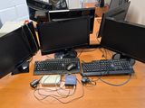 trois écrans d'ordinateur et un clavier posés sur un bureau