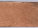 an old piece of brown paper on a white surface