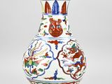 a white vase with a red and blue design on it