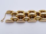 a close up of a gold chain with a bunch of bells on it