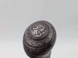 a close up of a wooden stick with a metal handle