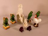 many figurines of animals and birds on the table