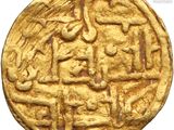 a close up of a gold coin on a white background