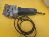 a corded sander on a yellow table