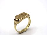 a close up of a gold ring with a diamond on it