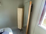 an image of a bedroom with a bed and a mirror