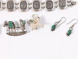 a lot of jewelry that is laying out on the table