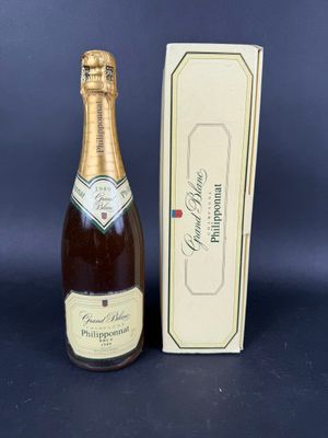 a close up of a bottle of champagne next to a box