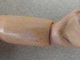 a toy hand that is holding something in it ' s right hand