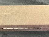 an empty box sitting on top of a black cloth covered table