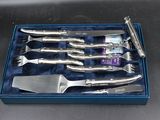 four knives in a blue box on a table
