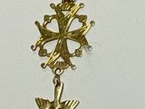 a gold cross with a bird on it hanging from a chain