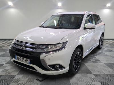 la voiture blanche est garée sur un sol en damier dans le garage