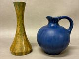 two vases sitting next to each other on a table
