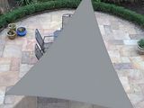 an aerial view of a patio area with a table, chairs, and a large triangle shade