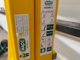 a close up of a yellow fire hydrant with stickers on it