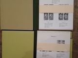 several pages of paper are stacked on top of each other on a wooden floor