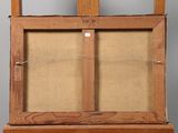 an old wooden easel with a glass door on top of it