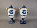 pair of blue and white vases with gold accents on stands