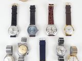 a lot of watches that are sitting on a table