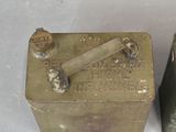 two old metal containers sitting side by side on a table