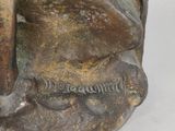 bronze statue of a man with a beard and a hat