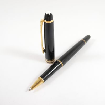 the pen is black and gold with a gold trim