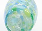 a glass vase that has a blue and green design on it