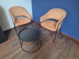 two chairs and a table in the corner of a room