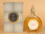 a close up of a bottle of perfume next to a box